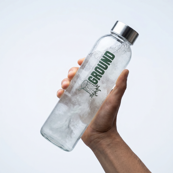 glass water bottle being shaken after adding ground electrolytes