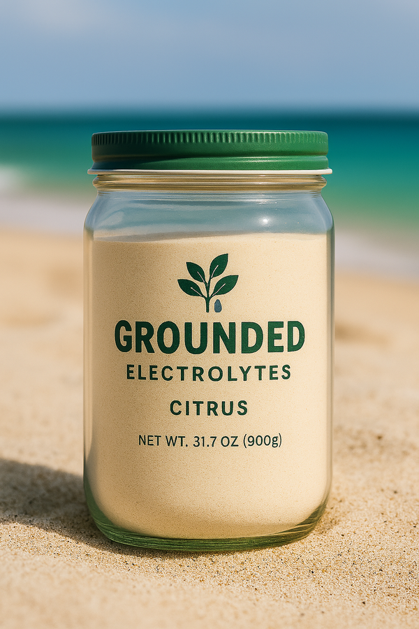 Image of jar of 'Grounded Electrolytes Citrus' on a sandy beach